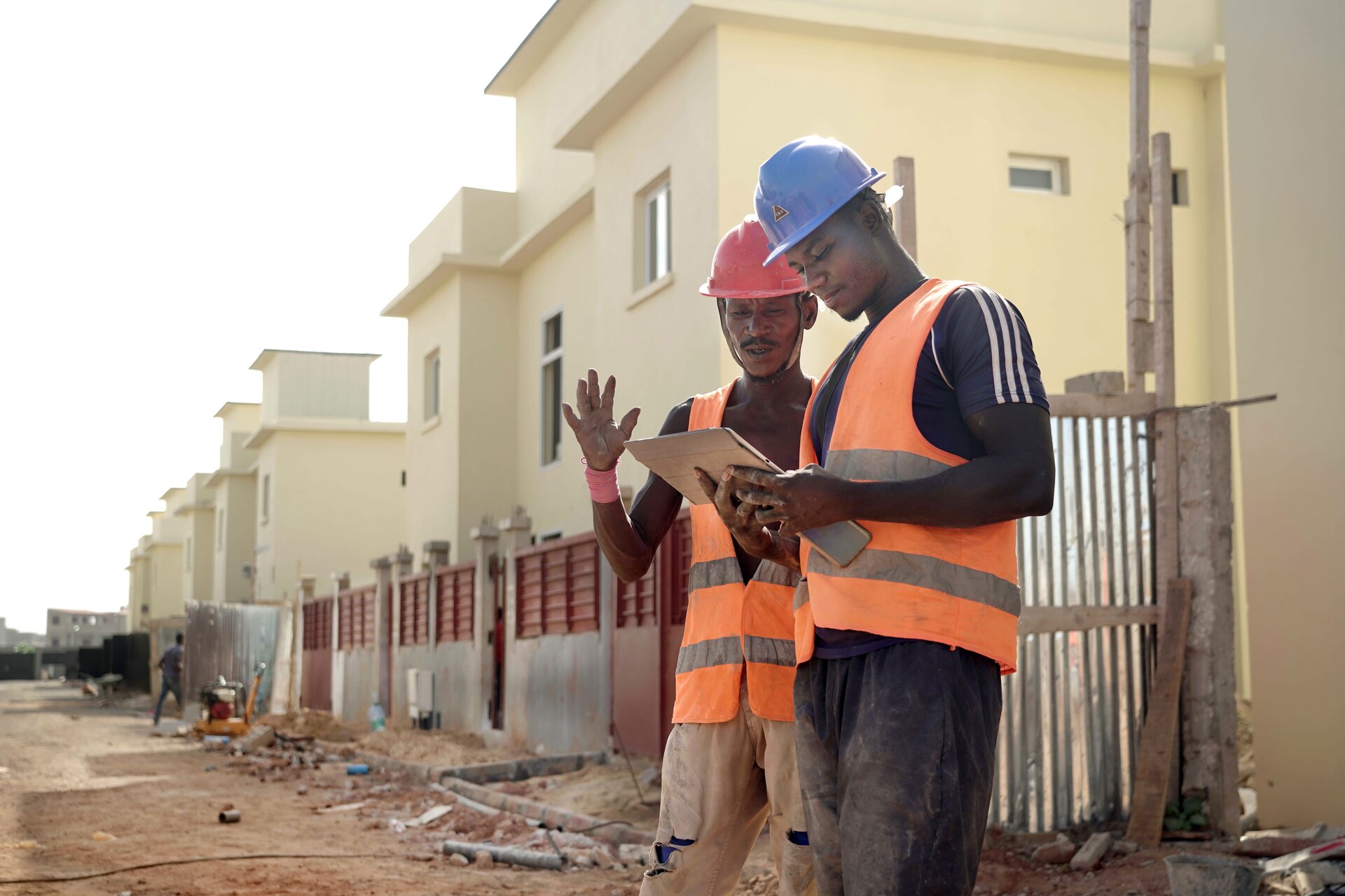 Construction field leaders coordinating work on an active job site