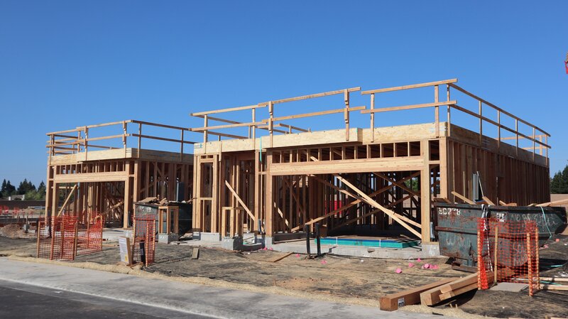 Multifamily residential construction site with wood framing and structural work in progress
