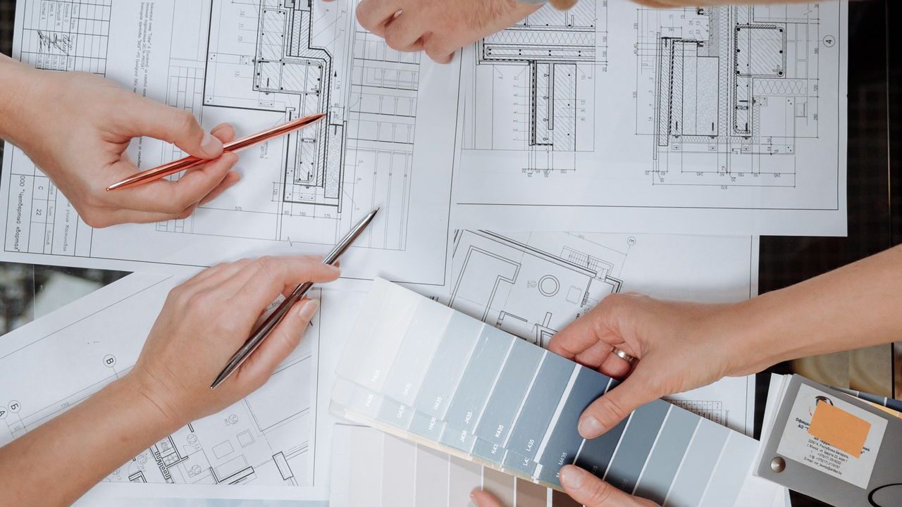 Construction professional annotating project blueprints during preconstruction review